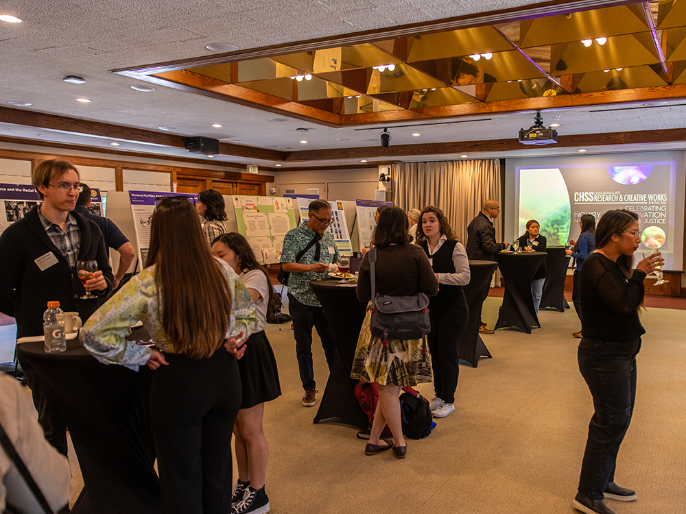 Students and faculty at CHSS showcase standing at tables